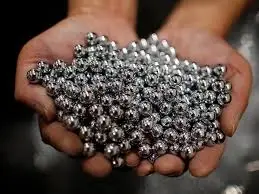 Hands holding a pile of small silver metal pellets